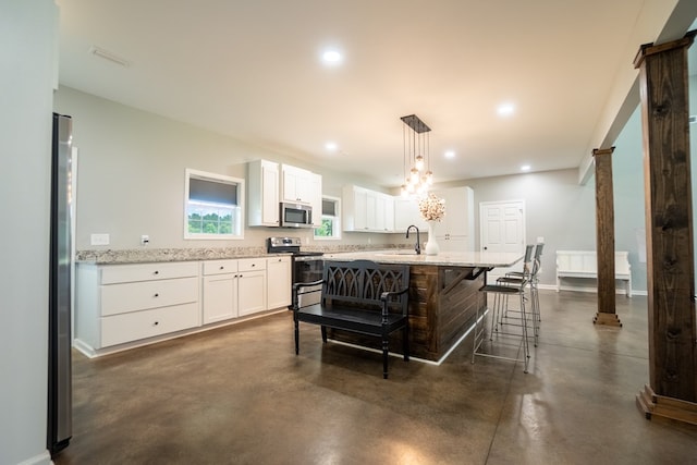 97 Eudon Best Rd, Ashford, AL 36312 - kitchen featuring appliances with stainless steel finishes, finished concrete floors, white cabinetry, recessed lighting, and a kitchen island with sink