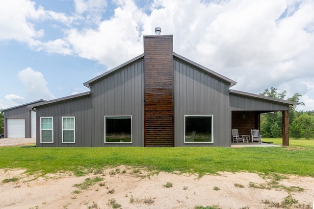 97 Eudon Best Rd, Ashford, AL 36312 - rear view of house featuring a chimney, a lawn, board and batten siding, and a patio area