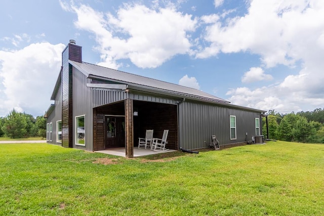 97 Eudon Best Rd, Ashford, AL 36312 - rear view of property with a chimney, central air condition unit, metal roof, a patio, and a yard