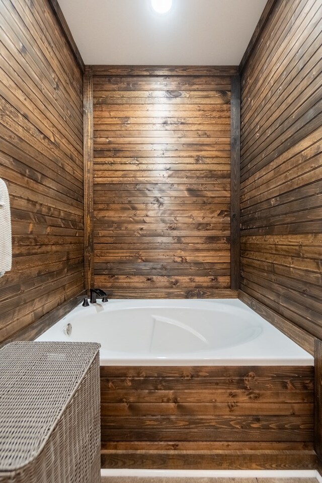 97 Eudon Best Rd, Ashford, AL 36312 - bathroom featuring wood walls and a bath