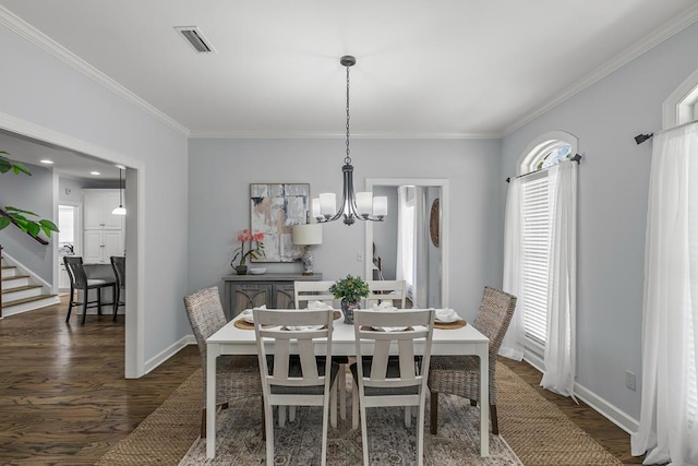 401 Gladstone Way, Dothan, AL 36303 - dining space with a chandelier, dark wood finished floors, crown molding, and stairway