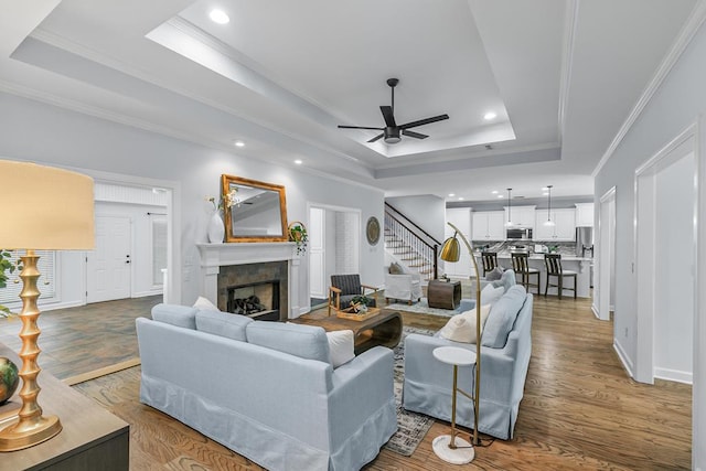 401 Gladstone Way, Dothan, AL 36303 - living area with a raised ceiling, stairway, a ceiling fan, a fireplace, and crown molding