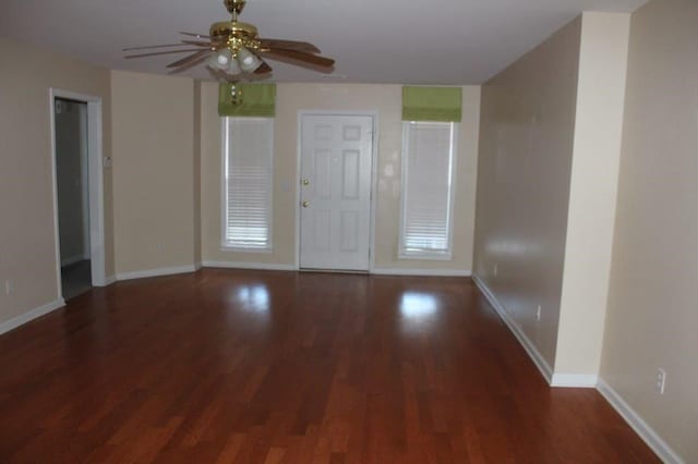 interior space with dark wood-type flooring and ceiling fan