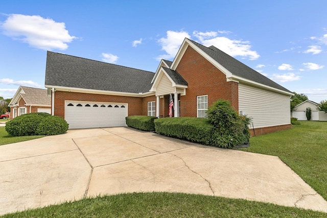 409 Drake Dr, Dothan, AL 36605 - view of front of house with brick siding, a garage, driveway, a front yard, and roof with shingles