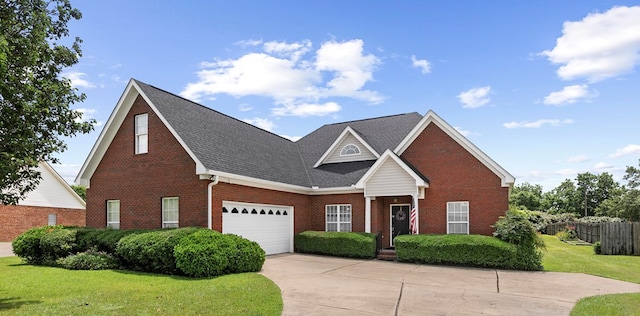409 Drake Dr, Dothan, AL 36605 - traditional home featuring brick siding, driveway, roof with shingles, and an attached garage