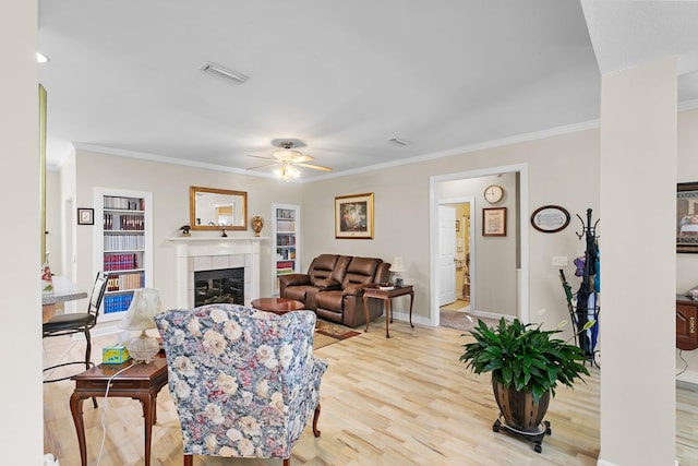 409 Drake Dr, Dothan, AL 36605 - living area featuring a ceiling fan, light wood-style floors, a fireplace, and crown molding