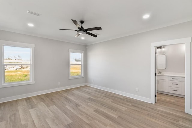 unfurnished bedroom with recessed lighting, light wood-style flooring, ornamental molding, a sink, and baseboards