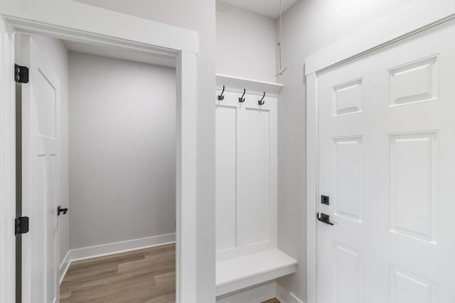 mudroom featuring wood finished floors and baseboards