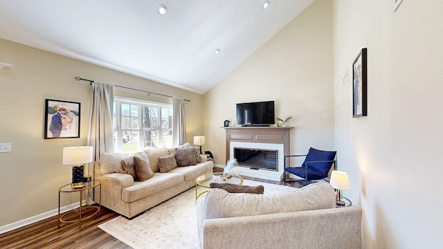 180 Fairway Woods Dr, Ozark, AL 36360 - living area with dark wood-style flooring, a glass covered fireplace, baseboards, high vaulted ceiling, and recessed lighting