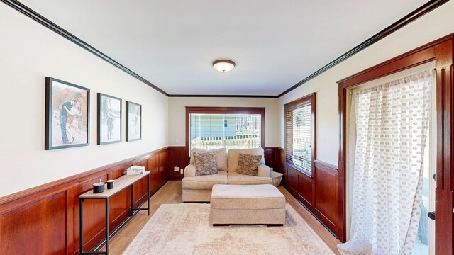 180 Fairway Woods Dr, Ozark, AL 36360 - sitting room featuring wainscoting, light wood finished floors, and ornamental molding