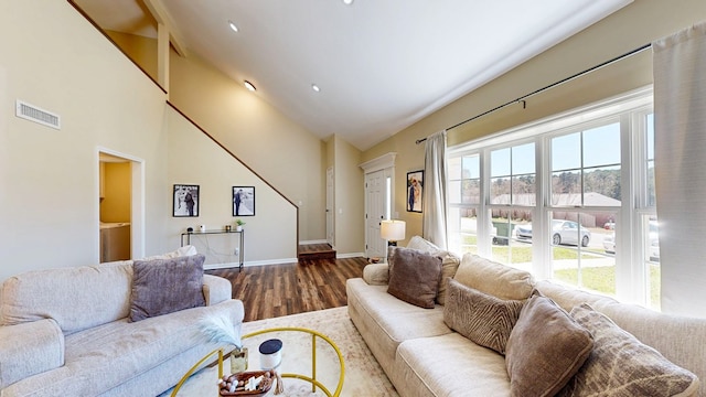 180 Fairway Woods Dr, Ozark, AL 36360 - living area with wood finished floors, plenty of natural light, baseboards, and high vaulted ceiling