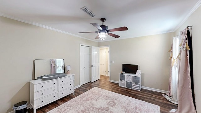 180 Fairway Woods Dr, Ozark, AL 36360 - bedroom with dark wood-type flooring, crown molding, baseboards, ceiling fan, and a closet