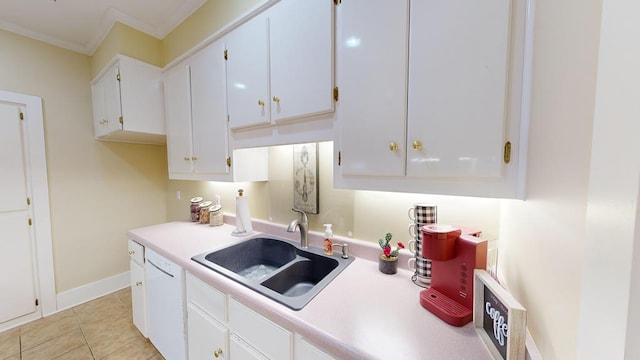 kitchen featuring white cabinetry, sink, light tile patterned flooring, and ornamental molding