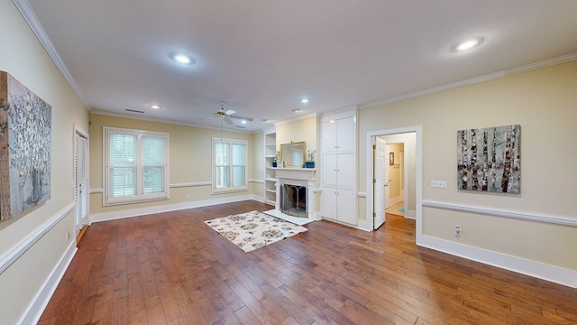 unfurnished living room featuring dark hardwood / wood-style floors, ceiling fan, and ornamental molding