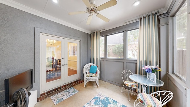 sunroom featuring ceiling fan and french doors