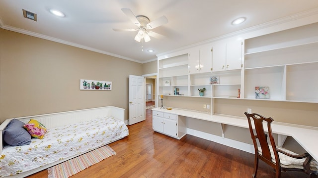 bedroom with hardwood / wood-style flooring, ceiling fan, and ornamental molding