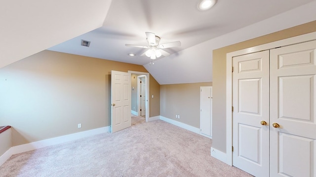 bonus room with light carpet, vaulted ceiling, and ceiling fan