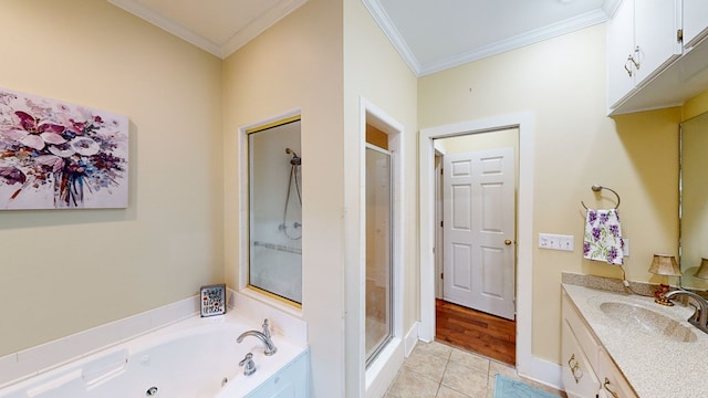 bathroom featuring tile patterned floors, vanity, ornamental molding, and independent shower and bath