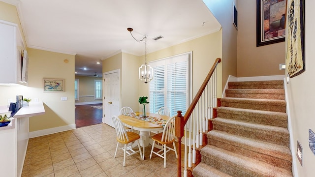 tiled dining area with crown molding and a chandelier