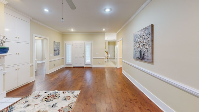 foyer with hardwood / wood-style flooring, ceiling fan, and ornamental molding