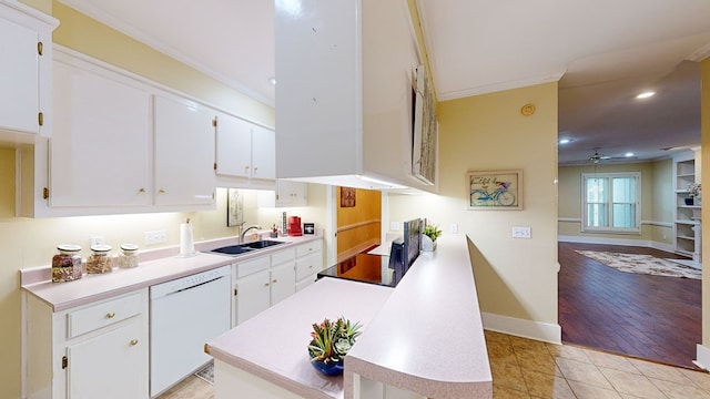 kitchen with white dishwasher, white cabinetry, light wood-type flooring, and sink