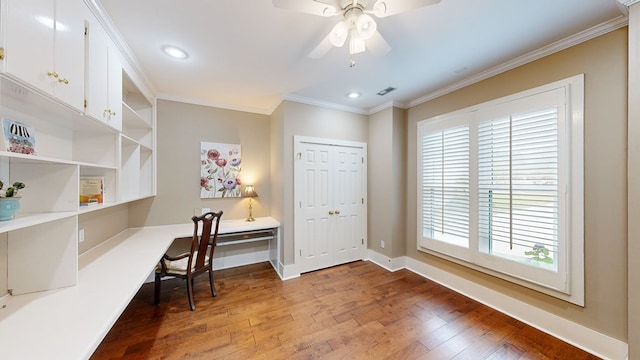 home office featuring wood-type flooring, built in desk, ceiling fan, and ornamental molding