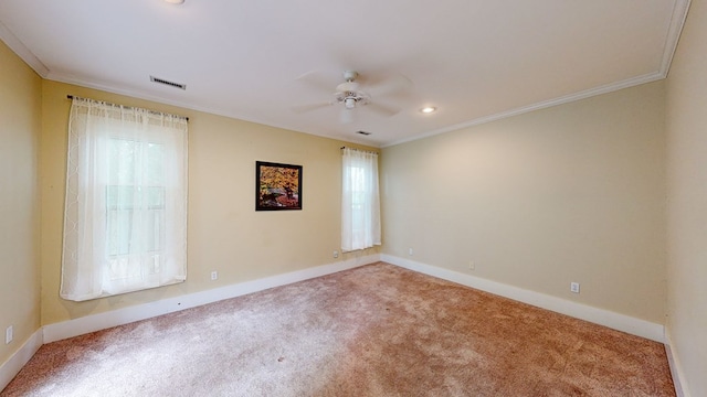 spare room featuring crown molding, carpet, and ceiling fan