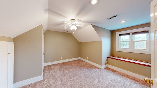 additional living space featuring light carpet, ceiling fan, and lofted ceiling