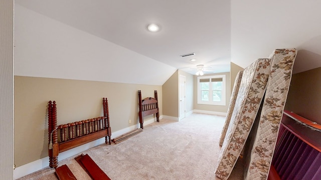 additional living space with ceiling fan, light colored carpet, and vaulted ceiling