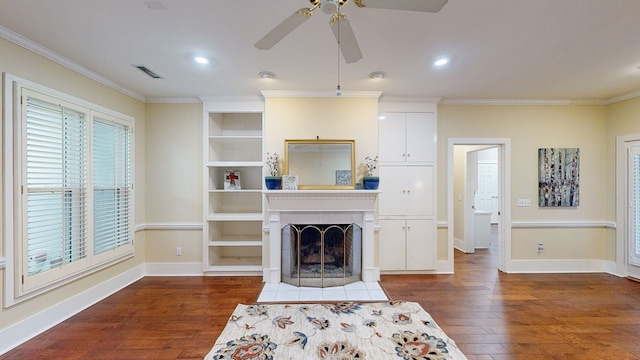 living room with crown molding, ceiling fan, and dark wood-type flooring