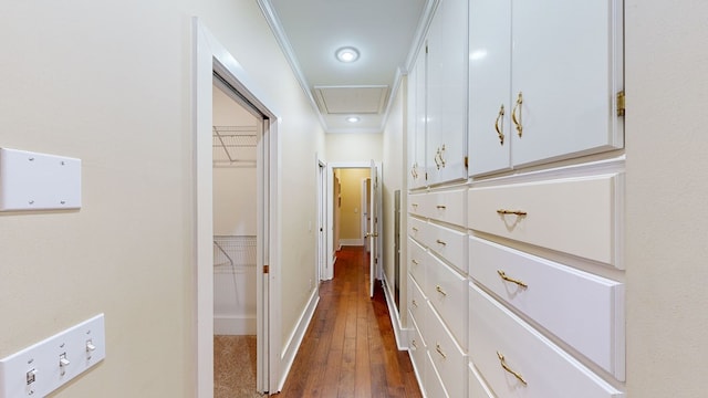 corridor featuring dark hardwood / wood-style floors and crown molding