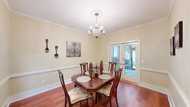 dining room with wood-type flooring, french doors, and ornamental molding