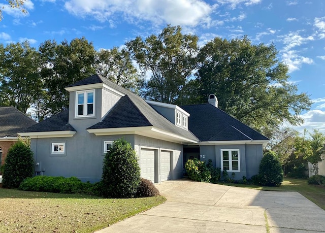 view of front of house with a garage and a front lawn