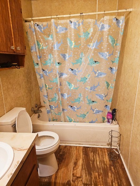 full bathroom featuring toilet, vanity, shower / bath combo, and hardwood / wood-style flooring