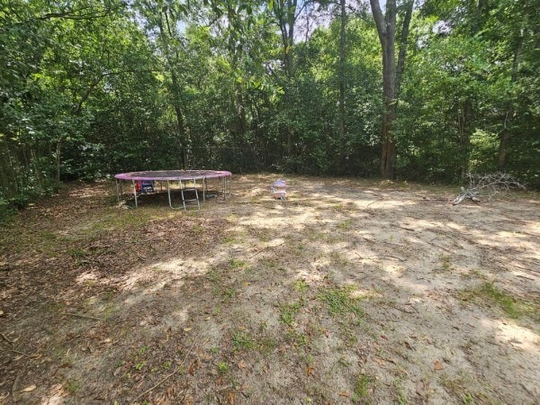 view of yard with a trampoline