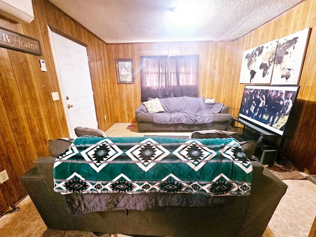 bedroom with a textured ceiling, wood walls, and carpet