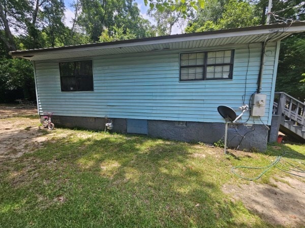 view of property exterior with a yard