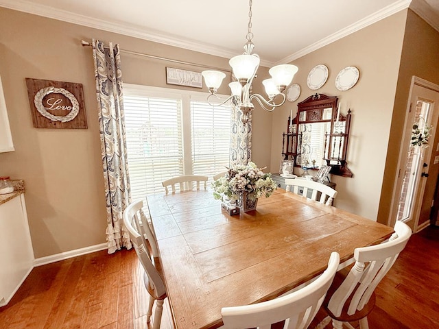 118 Brookstone Ct, Headland, AL 36345 - dining space featuring an inviting chandelier, baseboards, crown molding, and wood finished floors