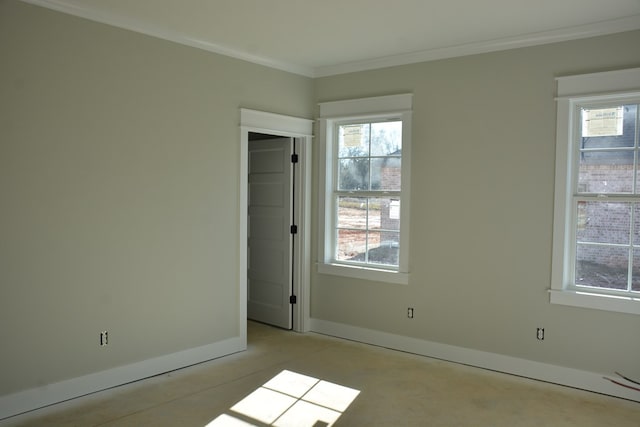 unfurnished room featuring a wealth of natural light and crown molding