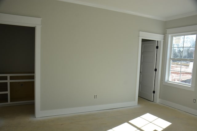 unfurnished bedroom with a closet and crown molding