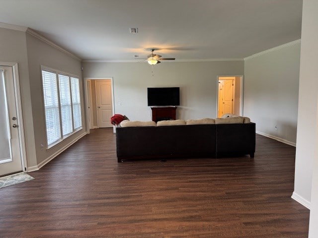 70 Beckett Ln, Newton, AL 36352 - living area with baseboards, a ceiling fan, dark wood-style flooring, and crown molding