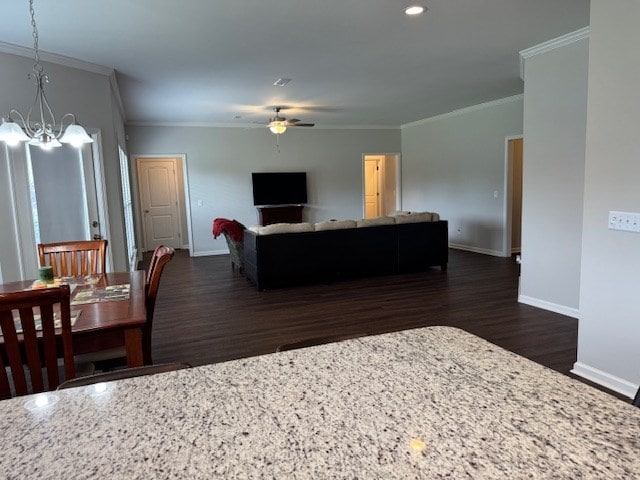70 Beckett Ln, Newton, AL 36352 - living area featuring ornamental molding, dark wood finished floors, baseboards, a ceiling fan, and a chandelier