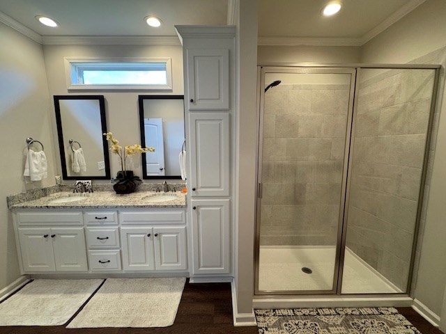 70 Beckett Ln, Newton, AL 36352 - full bathroom with a shower stall, crown molding, double vanity, wood finished floors, and recessed lighting