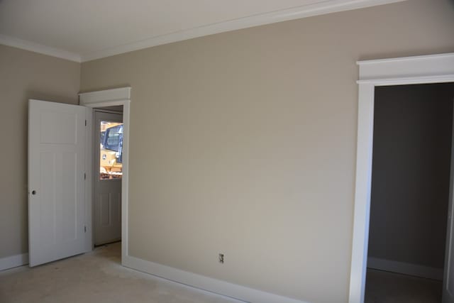 unfurnished room featuring crown molding