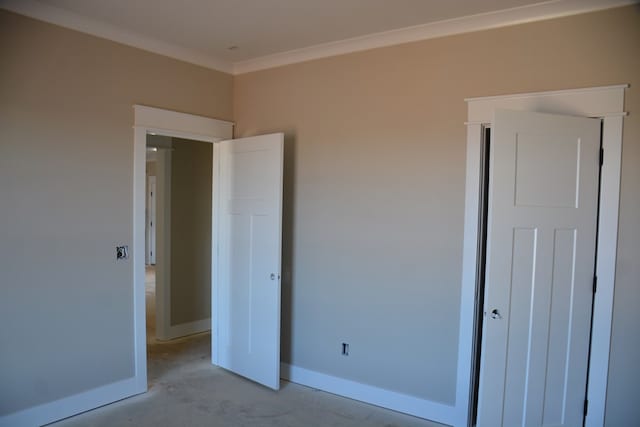 unfurnished bedroom featuring crown molding