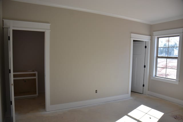 unfurnished bedroom with a closet and ornamental molding