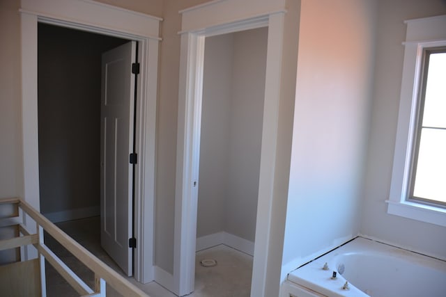 bathroom featuring a washtub and a healthy amount of sunlight