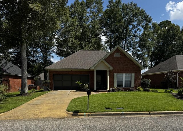 117 Lawrenceburg Ct, Dothan, AL 36305 - view of front of home featuring an attached garage, brick siding, driveway, and a front lawn