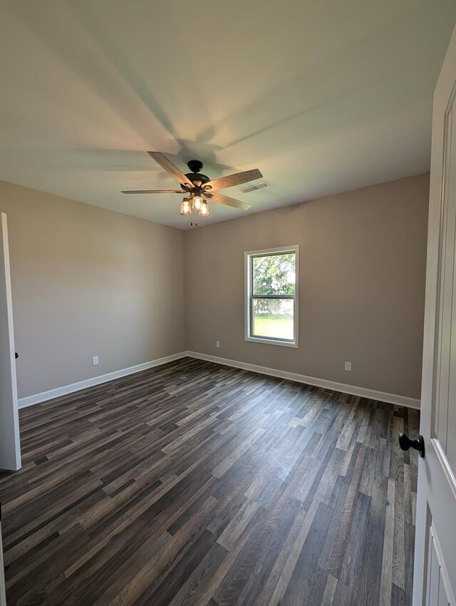 12611 Fortner St, Newton, AL 36352 - unfurnished room with dark wood-style flooring, ceiling fan, and baseboards