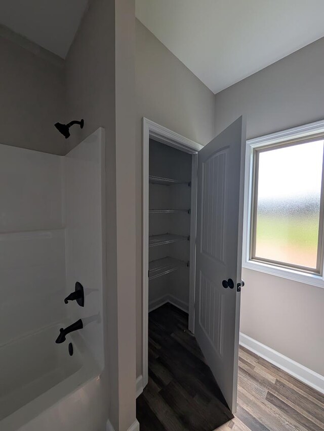 12611 Fortner St, Newton, AL 36352 - bathroom with bathing tub / shower combination, wood finished floors, and baseboards
